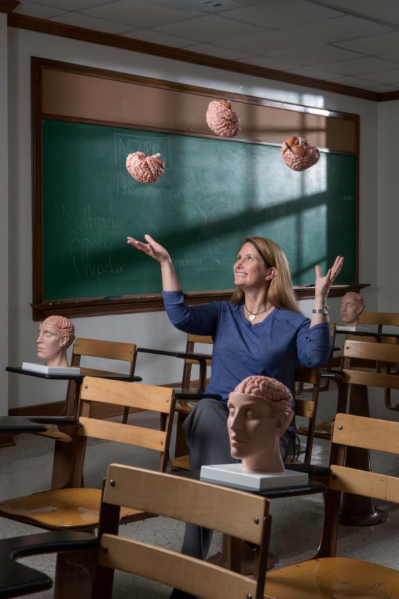 Dr. McDowell juggles brain models in a classroom