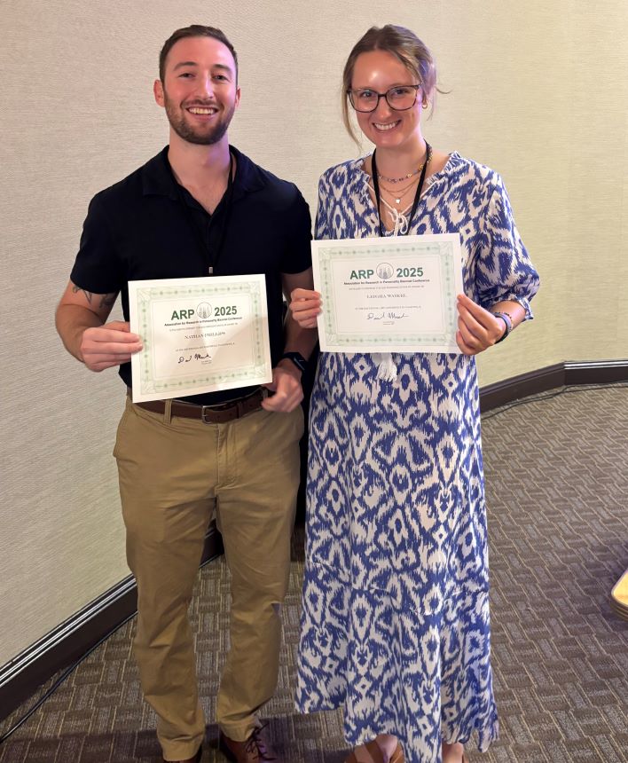 Nate Phillips and Leigha Rose Waikel holding their award certificates