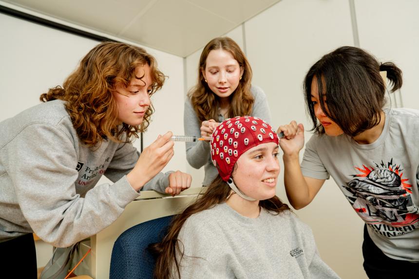 Students injecting fluid into a head cap.