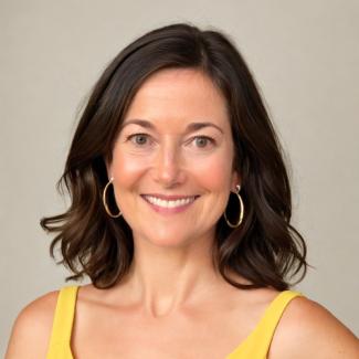 Photo of Becky Winkler wearing a yellow top and smiling